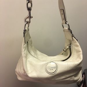 White patent coach purse. Lime green inside